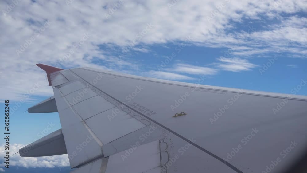 View through an airplane window on the sky and clouds. Aerial view Clouds and sky as seen through window of an aircraft. 4K video. Aerial footage. Travel concept. View through an airplane window on the sky and clouds. Aerial view Clouds and sky as seen through window of an aircraft. 4K video. Aerial footage. Travel concept.