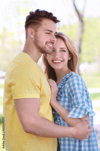 Happy young couple in park ...