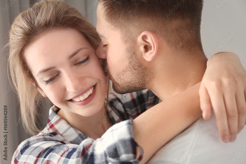 Happy young couple at home, closeup