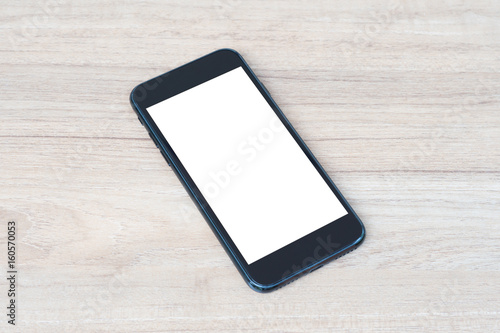 blank screen mobile phone on wooden table