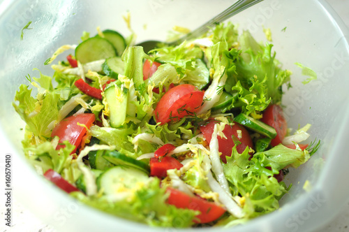 Fresh vegetable salad with tomato, cucumber and salad frisee