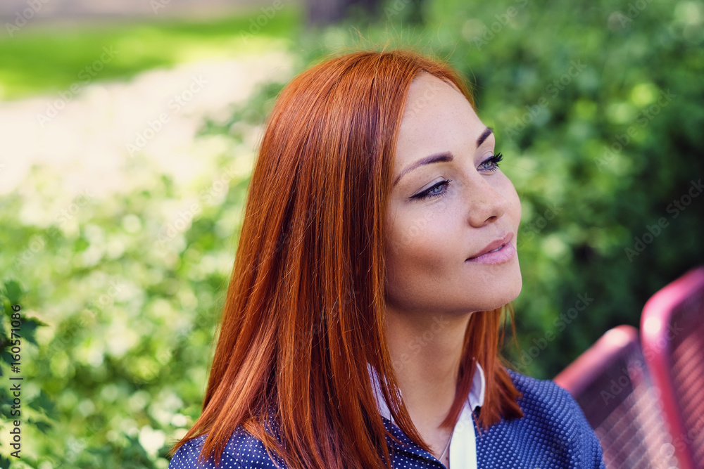 Portrait of redhead female outdoor.