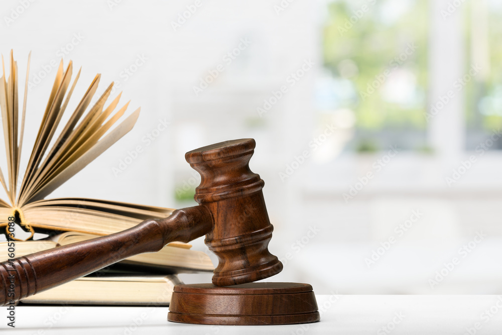 Wooden gavel and books on wooden table Wooden gavel and books on wooden table