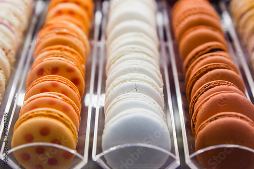 Brown, white and orange macaroons in intalian shop photo