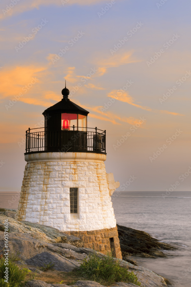 Lighthouse on a rocky shore.