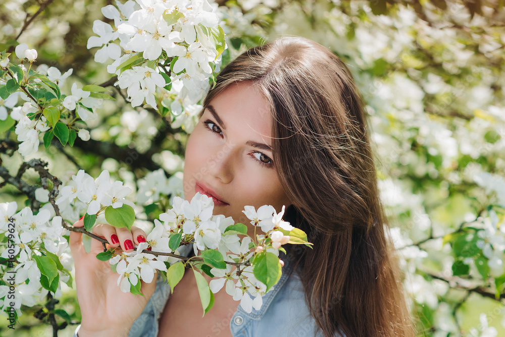 Woman near blooming apple tree