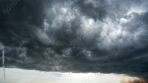 clouds with background,sunlight through very dark clouds background of dark storm clouds,black sky Background of dark clouds before a thunder.