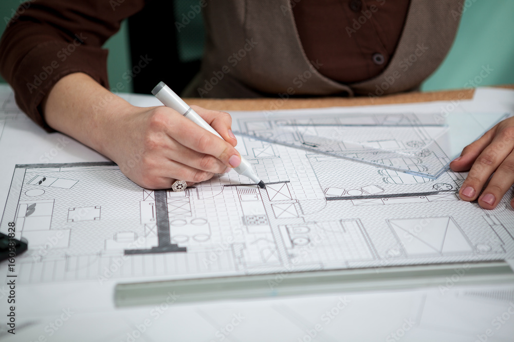 Close up of architect hands working on blueprints. Working on new projects. Architecture and design Close up of architect hands working on blueprints. Working on new projects. Architecture and design
