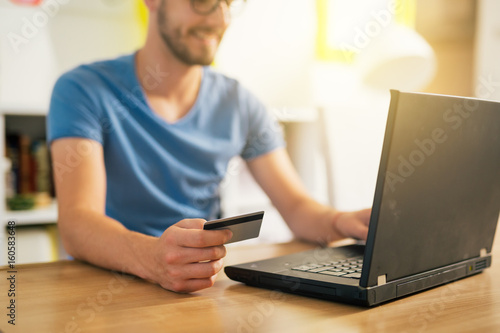 online shopping. Man using his credit card for online shopping