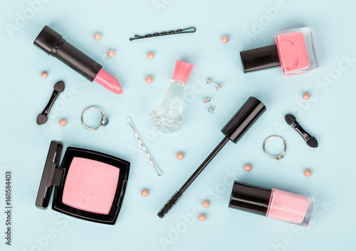 set of professional decorative cosmetics, makeup tools and accessory on blue background. beauty, fashion and shopping concept. flat lay composition, top view