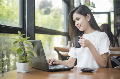 Free Download  Beautiful business girl working with tablet , smartphone and drinking coffee in coffee shop - GFXLoad