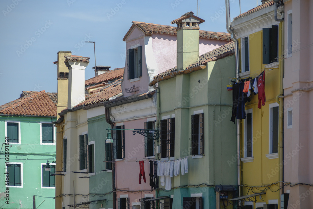 BURANO, ITALY - APRIL 18, 2009: Street with colorful buildings in Burano island, a gracious little town full of canals, near Venice - Italy 