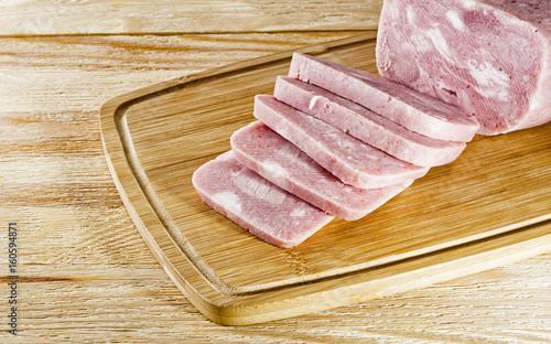 A piece of ham on wooden background