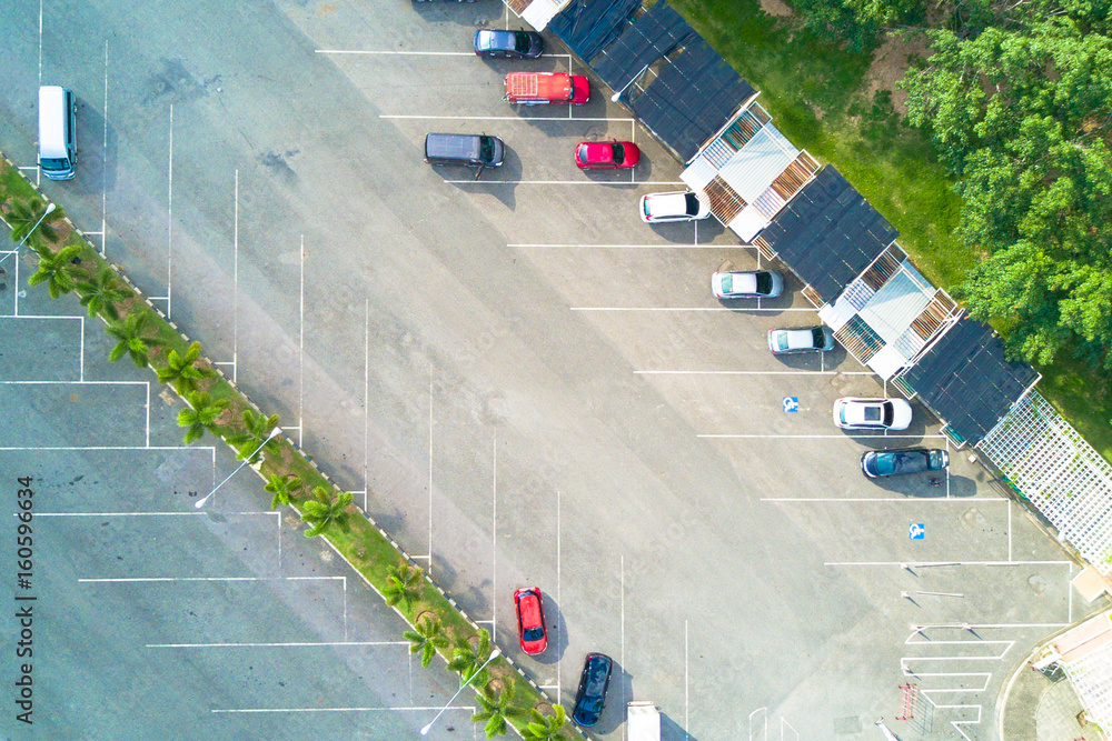 Aerial view of parking lot with different cars park in the garden