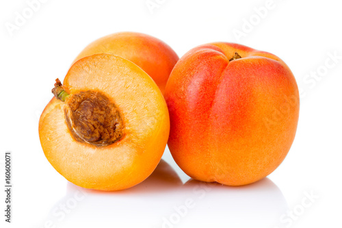 Ripe apricot fruits with slice isolated on white