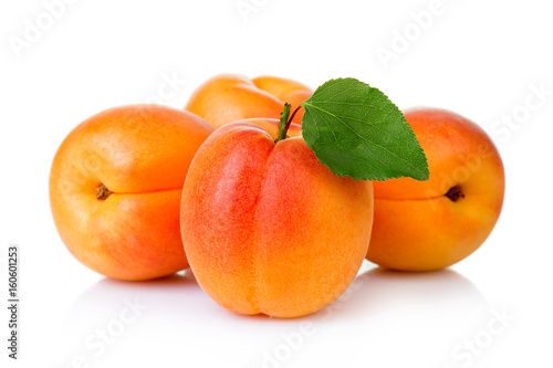 Ripe apricot fruits with green leaf isolatet on white