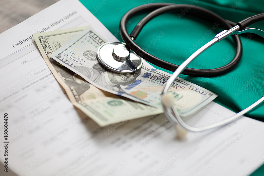 Dollars with stethoscope on them. Costs for the medical insurance. Dollars with stethoscope on them. Costs for the medical insurance.