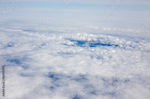Above view of white clouds and a horizon with a blue sky. © Mariiam