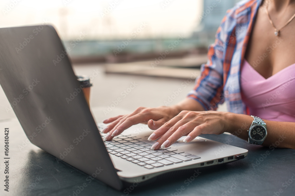 Close up shot of female hands typing on a laptop keyboard Close up shot of female hands typing on a laptop keyboard