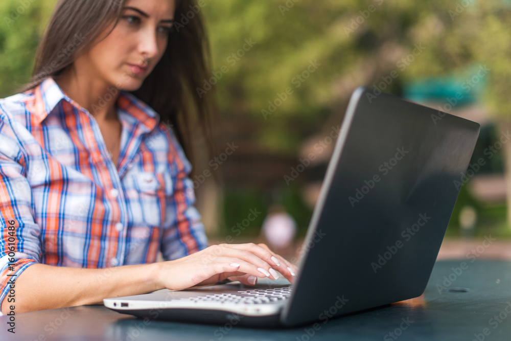 Close up shot of female hands typing on a laptop keyboard Close up shot of female hands typing on a laptop keyboard