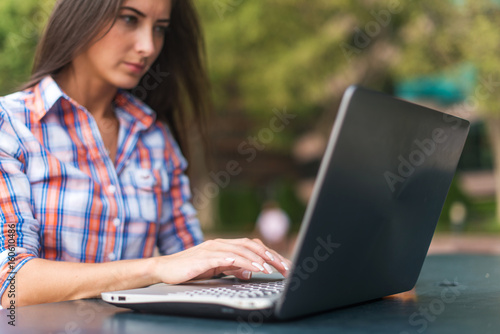 Close up shot of female hands typing on a laptop keyboard