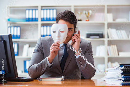 Fényképezés Businessman with mask in office hypocrisy concept