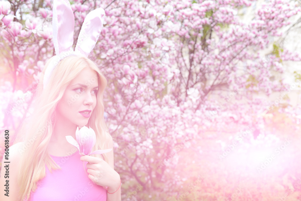 girl with bunny ears holding magnolia flower