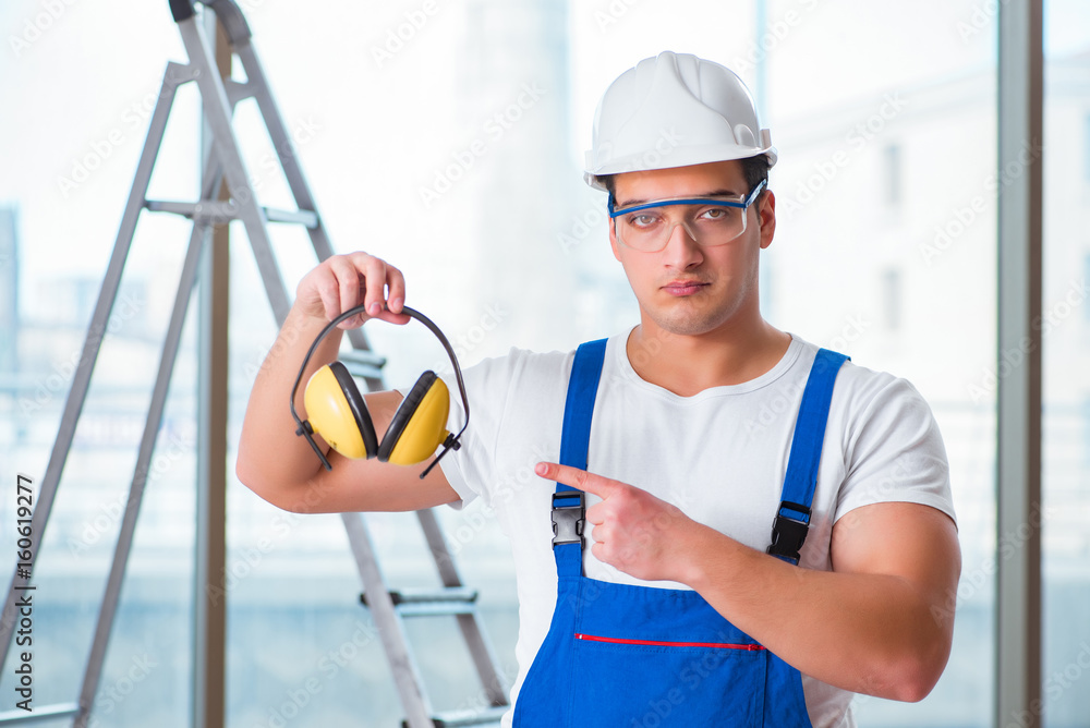 Young worker with noise cancelling headphones Young worker with noise cancelling headphones