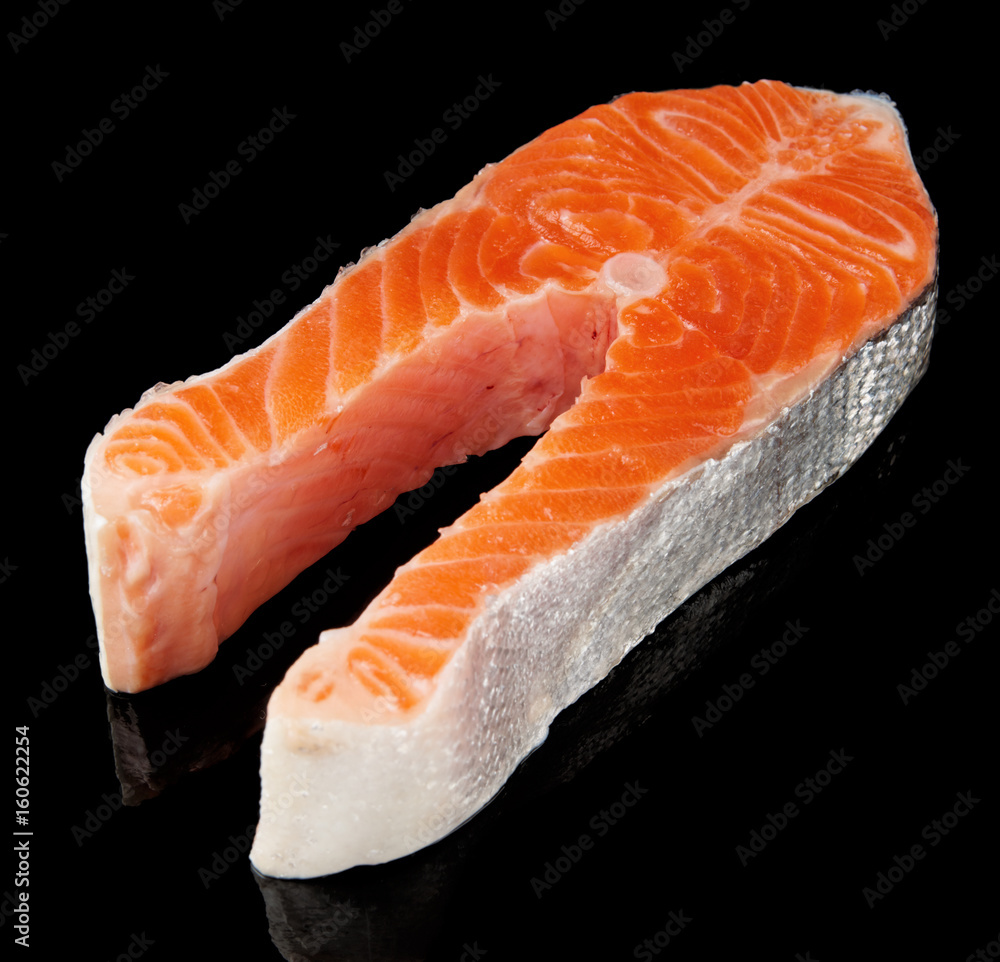 Raw fresh salmon steak isolated on black Raw fresh salmon steak isolated on black