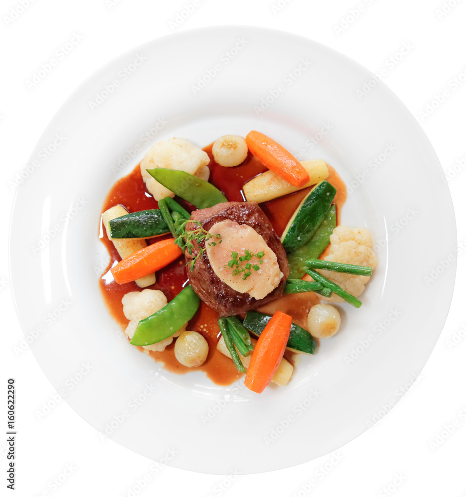 Tenderloin steak with vegetables and bone marrow isolated on white Tenderloin steak with vegetables and bone marrow isolated on white