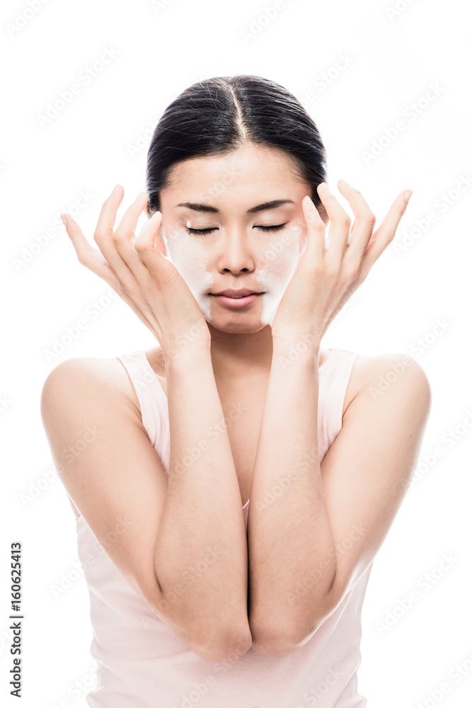 Beautiful young Asian woman applying facial moisturizer cream for sensitive skin care Beautiful young Asian woman applying facial moisturizer cream for sensitive skin care