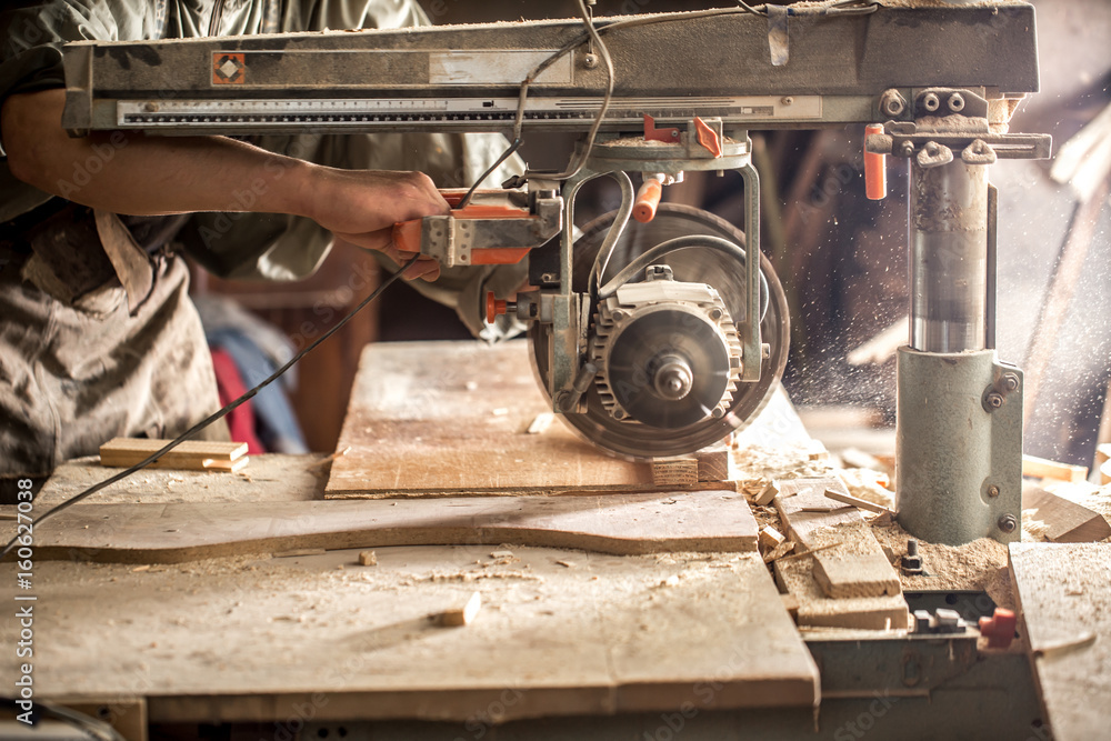 a man working with wood product on the machine a man working with wood product on the machine