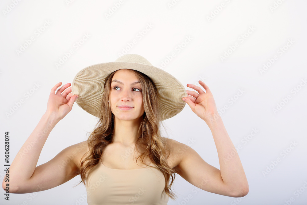 Young woman in straw hat on white background Young woman in straw hat on white background
