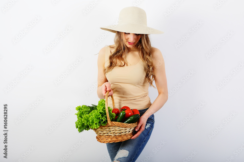 Young woman with healthy food, vegetables, wicker basket, on white background