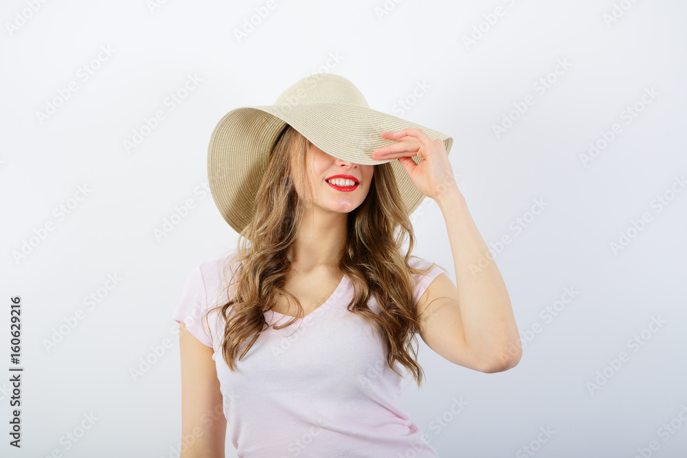 Smiling girl in straw hat, playfull, feminine, on white background, beauty Smiling girl in straw hat, playfull, feminine, on white background, beauty
