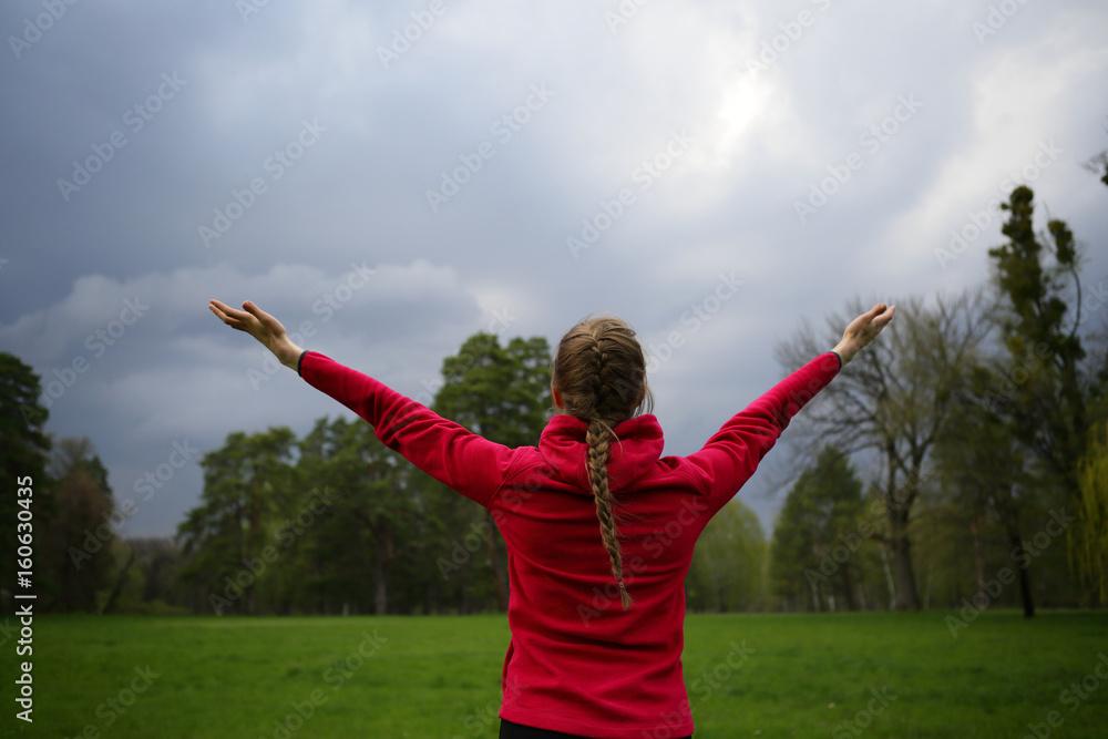 Hands up woman on nature, sky, green, park, outdoor, healthy lifestyle, standing back Hands up woman on nature, sky, green, park, outdoor, healthy lifestyle, standing back