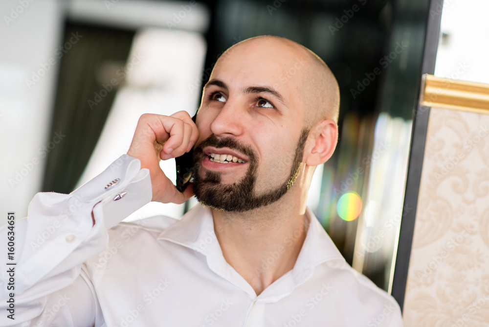 A brutal bald man talking on the phone. A brutal bald man talking on the phone.