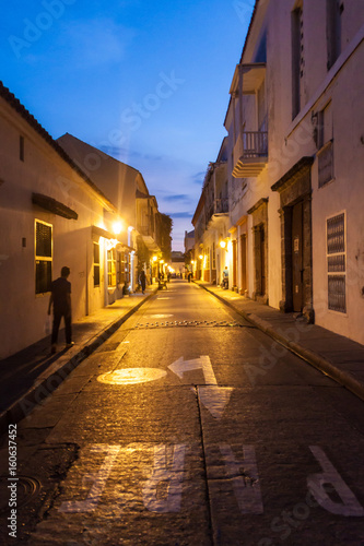 People walk at the streets of Cartagena de Indias (Colombia) during the evening.