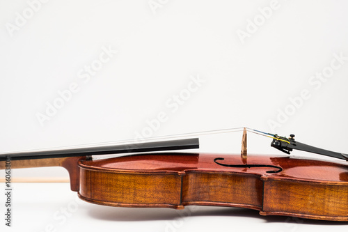 CLose up view of a violin with white plain background.