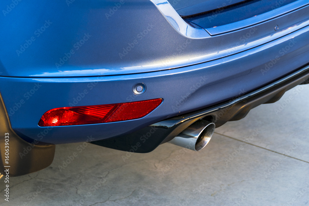 Rear bumper of a car with exhaust pipe, modern car exterior details