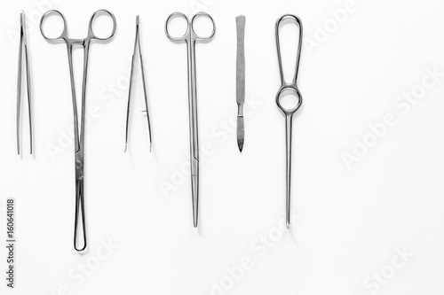 Medical instruments for plastic surgery on white backgrond top view copyspace