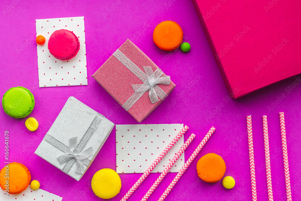 Birthday greeting cards and wrapped gifts on fuchsia background top view Birthday greeting cards and wrapped gifts on fuchsia background top view