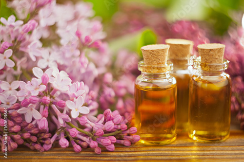 Essence of flowers on table in beautiful glass jar