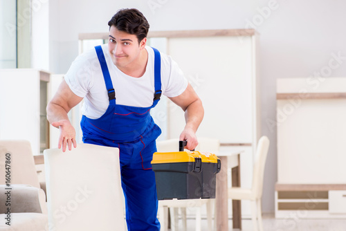 Furniture repairman working in store