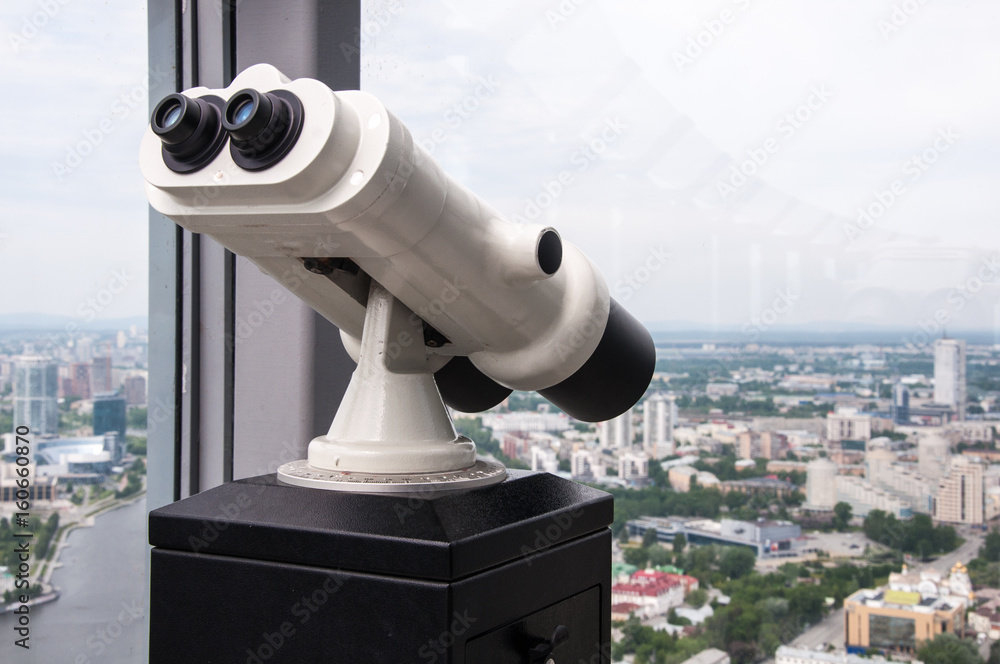 Binoculars on the observation desk on the roof of high building Binoculars on the observation desk on the roof of high building