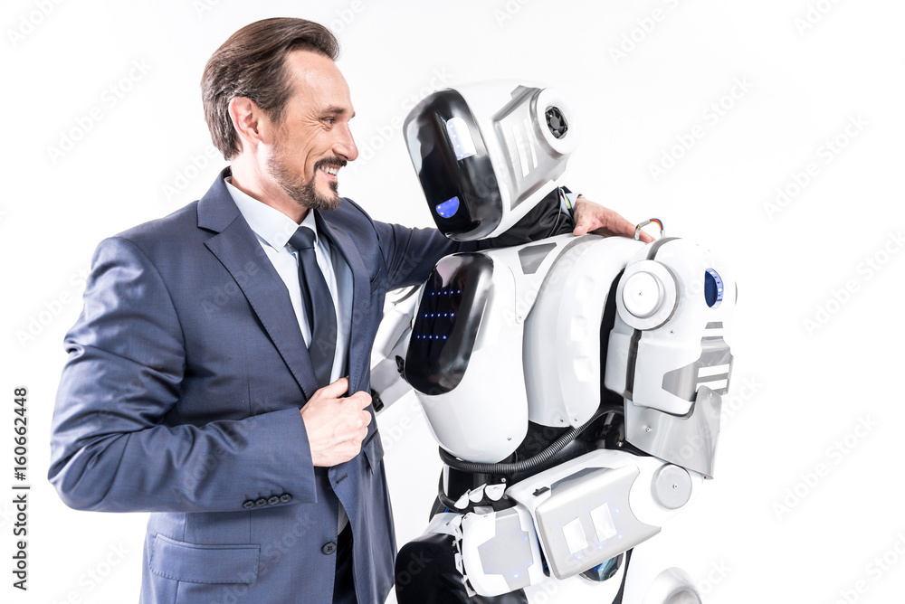 Cheerful smiling man embracing cyborg