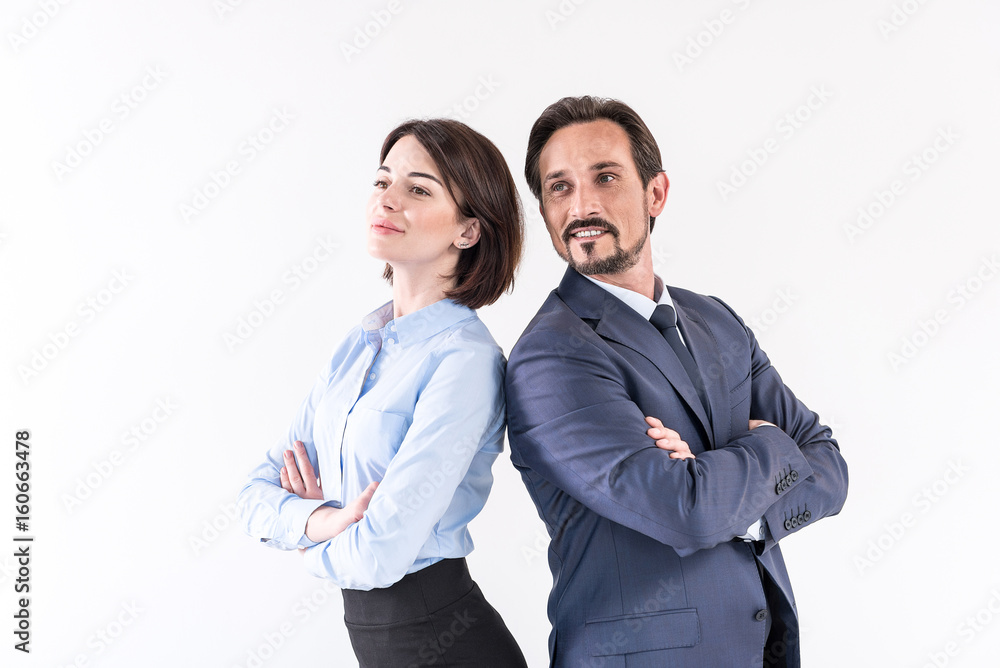 Positive mature man and young woman are posing together Positive mature man and young woman are posing together