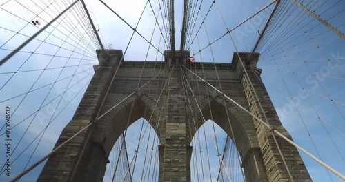 Looking up at one of the pillars of the Brooklyn Bridge on a summer day.  	