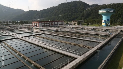 Taipei, Taiwan-05 December, 2015: View of the exterior of a water treatment plant located in Taipei, northern Taiwan. There are mountains on the horizon and vegetation around. photo