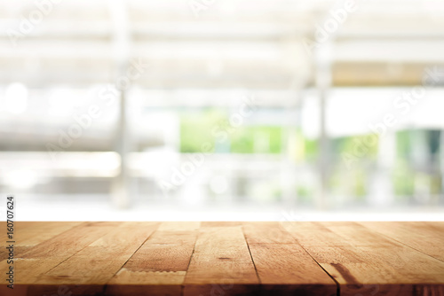 Wood table top on blur kitchen window background